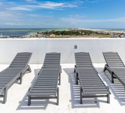 Soak up the sun on your private rooftop terrace with four lounge chairs and breathtaking panoramic views of the coastline.