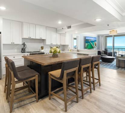 Your open kitchen flows into the living area with ocean views, featuring a spacious island perfect for morning coffee or evening conversations.
