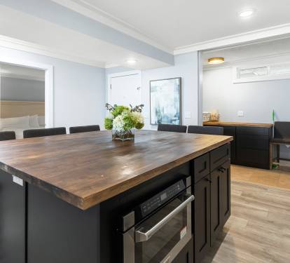 Your spacious kitchen island invites memorable meals with rich wood countertops, modern appliances, and elegant seating for eight.