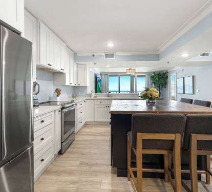 Your spacious kitchen invites you to cook with ocean views through the window while enjoying the marble island and stainless steel appliances.
