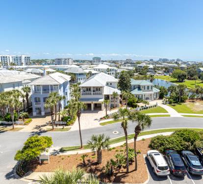 Beautiful coastal community with waterfront homes, palm-lined streets, and convenient parking in a vibrant neighborhood setting.