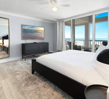 Wake up to stunning ocean views from your private balcony in this elegant bedroom, where coastal breezes and morning light create the perfect retreat.