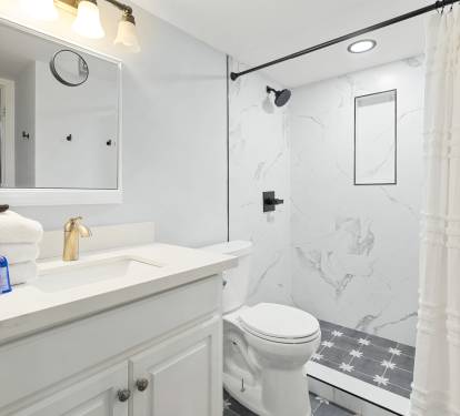 Step into your refreshing retreat with marble-look shower, plush towels, and thoughtful amenities waiting for your arrival.