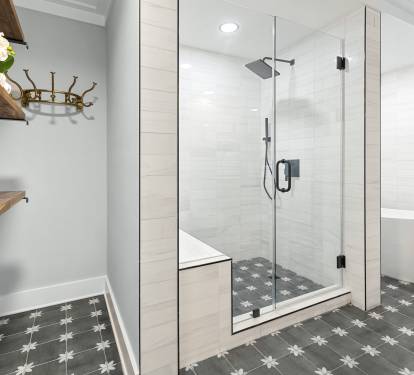 Indulge in your spa-like bathroom with a luxurious glass-enclosed shower and elegant freestanding tub.