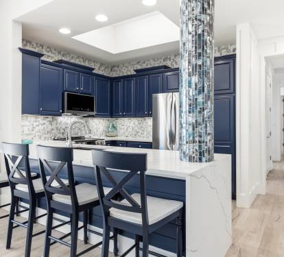 Your gourmet kitchen features navy cabinets, marble counters, and a stylish breakfast bar where you'll start each morning.