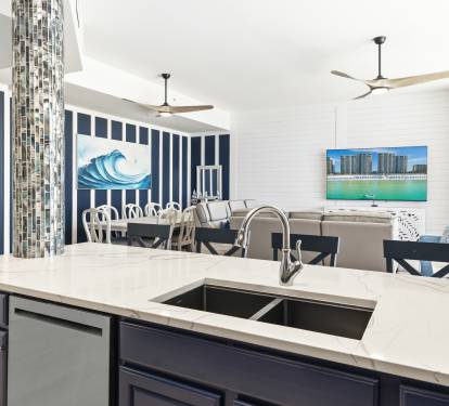 Your spacious kitchen flows beautifully into the dining and living areas, with beach-themed decor creating a coastal retreat atmosphere.