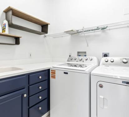 Your dedicated laundry room features full-size washer and dryer with convenient sink and storage for effortless care of your clothes.