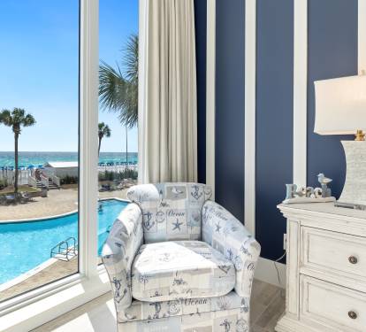 Wake up to breathtaking ocean views from your nautical-themed seating nook, overlooking the sparkling pool and pristine beach.