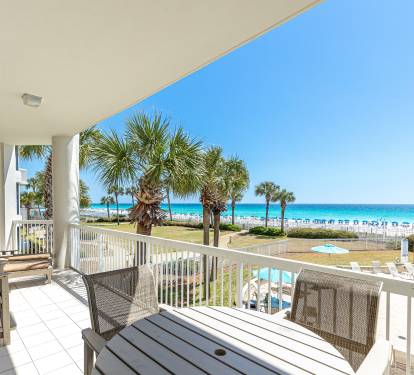 Relax on your private balcony with stunning ocean views, palm trees swaying below, and direct beach access just steps away.