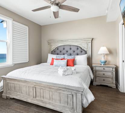Wake up to stunning ocean views in your cozy bedroom, where the ceiling fan keeps you cool and crisp linens await.