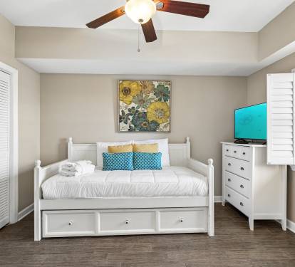 Relax in your bright bedroom with built-in storage, ceiling fan, and large windows that flood the space with natural light.