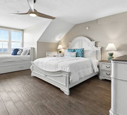 Drift off in your elegant bedroom featuring a plush king bed, cozy window seat, and gentle ceiling fan creating the perfect sleep sanctuary.