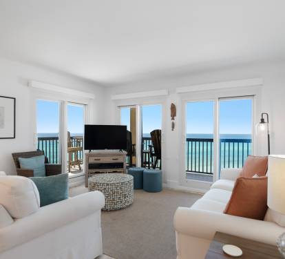 Unwind in your bright oceanfront living room where panoramic sea views stretch beyond French doors to your private balcony.