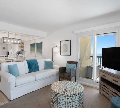 Your bright, coastal living room blends comfort with modern style, featuring gulf-inspired blues and a private balcony for morning coffee moments.