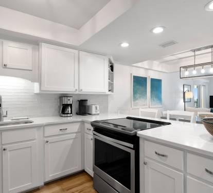 Your fully equipped kitchen features modern appliances and pristine white cabinetry, perfect for preparing meals during your stay.