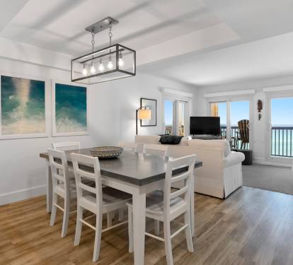 Relax in your bright oceanfront living space where coastal artwork and open-plan design create the perfect seaside retreat.