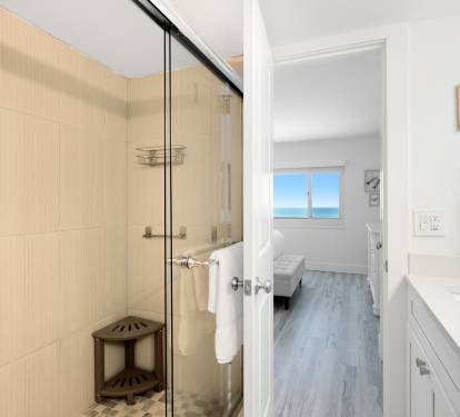 Your bright, modern bathroom features a spacious glass shower and opens to a bedroom with stunning gulf views.