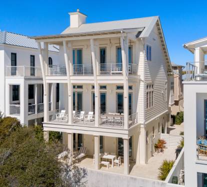 Stunning coastal architecture features multiple levels of covered porches and modern balconies in this beachside neighborhood.