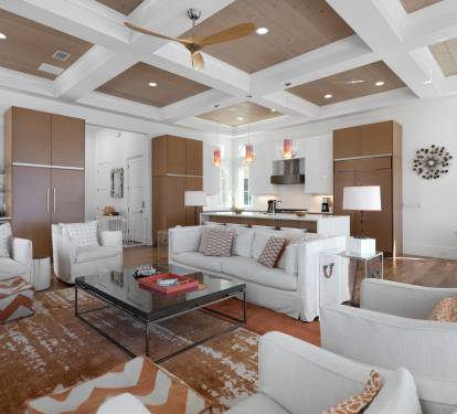 Relax in your spacious open-concept living space with soaring coffered ceilings and modern furnishings.