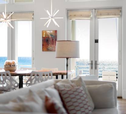 Relax in your bright, airy living space where modern furnishings meet stunning gulf views through floor-to-ceiling windows.