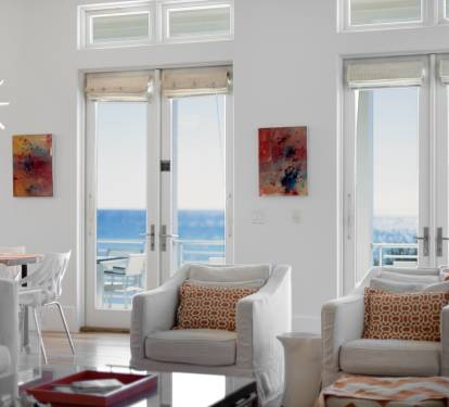 Relax in this bright living space where floor-to-ceiling windows frame stunning gulf views and modern comfort awaits.