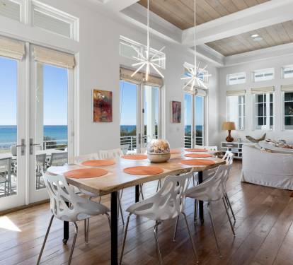 Your dream dining room awaits with gulf views stretching beyond floor-to-ceiling windows, where every meal becomes a coastal celebration.