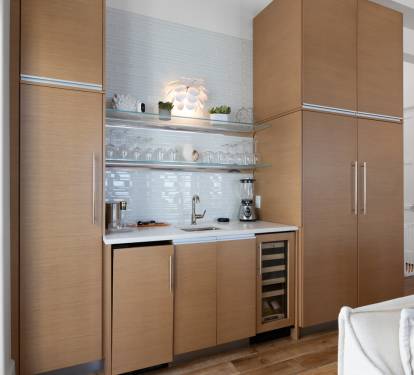 Your stylish kitchenette features sleek wood cabinetry, modern appliances, and gleaming countertops, perfect for preparing morning coffee or evening snacks.