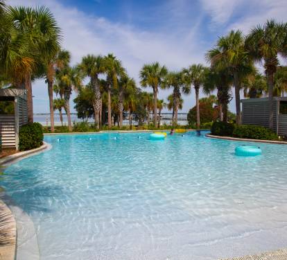Tropical pool paradise framed by swaying palms, with crystal-clear waters and beach access just steps away.