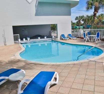 Dive into your private pool oasis, where crystal-clear waters await beneath swaying palms and endless blue skies.