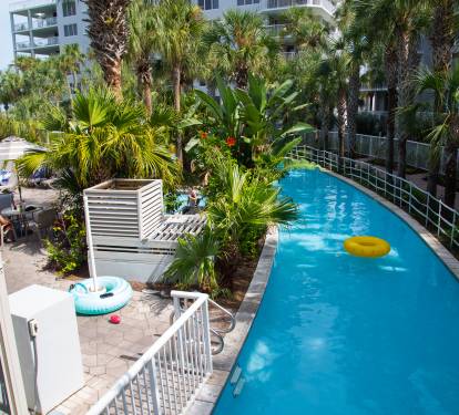 Crystal-clear pool surrounded by swaying palms creates your private tropical oasis for endless relaxation and fun.