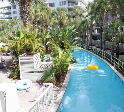 Tropical pool paradise awaits with crystal-clear waters surrounded by lush palms and modern comfort.