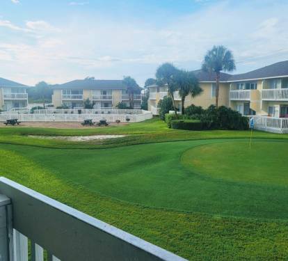 Wake up to stunning golf course views from your private balcony, with perfectly manicured greens stretching toward palm-lined grounds.
