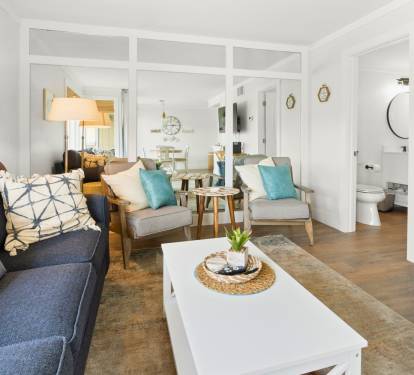 Relax in your bright, coastal-inspired living space with comfy seating, nautical touches, and an open layout perfect for unwinding.