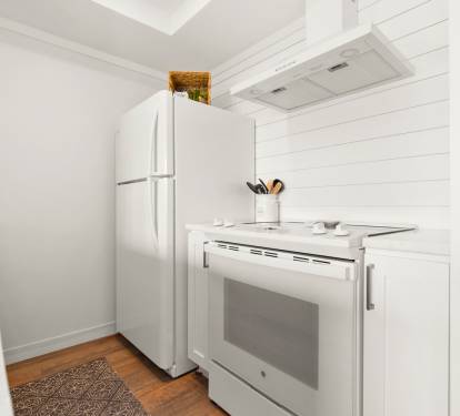 Your bright, well-equipped kitchen features modern appliances and crisp white finishes, perfect for preparing meals during your stay.