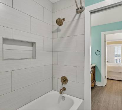 Step into your private bathroom featuring a relaxing tub-shower combo with modern fixtures and soothing neutral tones, connecting seamlessly to your bedroom retreat.
