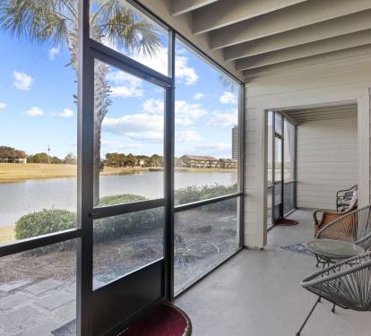 Private screened patio with peaceful golf course and lake views—perfect for relaxing morning coffee or sunset unwinding.