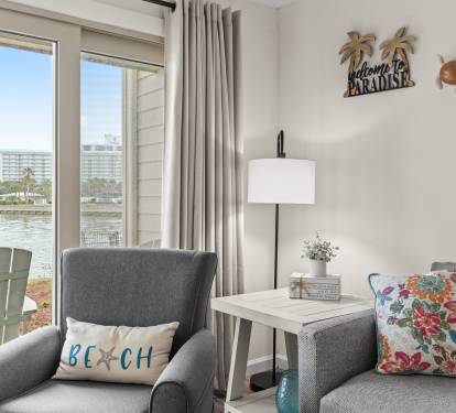 Settle into your waterfront paradise with coastal charm and stunning lake views from your cozy seating area.