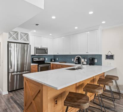 Your fully equipped kitchen features modern appliances, stylish island seating, and everything needed for memorable meals together.