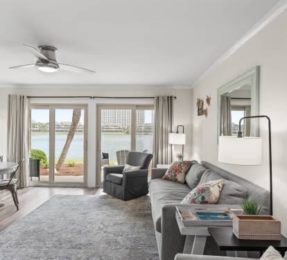 Unwind in your spacious waterfront living room with stunning lake views through floor-to-ceiling windows.