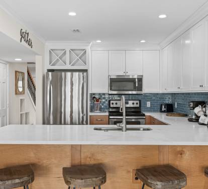 Your gourmet kitchen awaits with stainless steel appliances, granite counters, and a breakfast bar where morning coffee tastes even better.