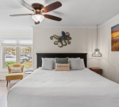 Drift off in your serene bedroom, where coastal charm meets comfort with thoughtful decor and gentle ceiling fan breezes.