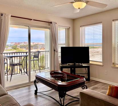 Relax in your bright living space where water views frame every moment. Unwind on plush seating, enjoy entertainment on the flat-screen TV, and step onto your private balcony to soak in the coastal scenery.