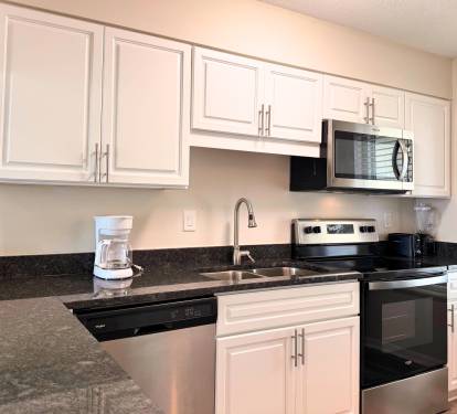 Your fully equipped kitchen features modern appliances, granite countertops, and plenty of cabinet space—perfect for preparing meals during your stay.