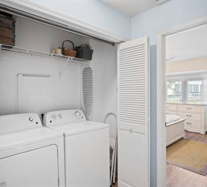 Convenient laundry closet with a full-size washer and dryer.