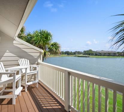 Peaceful private balcony overlooking a scenic lake. Features outdoor seating—perfect for morning coffee or sunset views.
