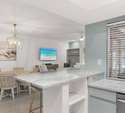 Bright and breezy, this open layout features coastal tones, sleek counters, and relaxed beachy charm.