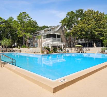 Dive into relaxation at the resort-style pool, surrounded by shade trees, loungers, and peaceful charm.