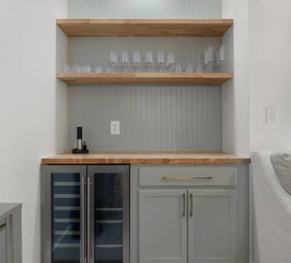 Chic built-in bar with wood accents and wine cooler—perfect for relaxing with your favorite vintage.