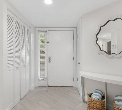 This bright, coastal entryway welcomes you with soft tones, beachy accents, and a clean, airy feel.