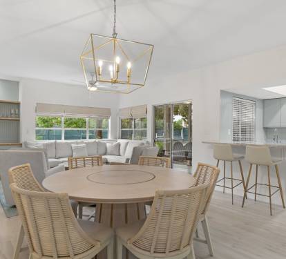 Open and inviting, this coastal dining area flows into a light-filled living space with relaxed, breezy style.